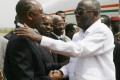 Phillipe Henry Dacoury-Tabley (G) et le President Laurent Gbagbo (AFP PHOTO / KAMBOU SIA )