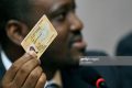 Ivory Coast prime minister Guillaume Soro shows his national identity card during an official ceremony when candidates present their identity cards in Abidjan on October 1, 2010. The Ivory coast is gearing up for presidential elections to be held on October 31, 2010. AFP PHOTO/ SIA KAMBOU (Photo credit should read SIA KAMBOU/AFP/Getty Images)